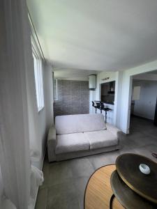 a living room with a couch and a table at Appartement élégant avec vue et climatisation in Fort-de-France