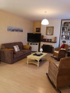 a living room with couches and a coffee table at Le cœur de saint Florent in Saint-Florent +7 photos