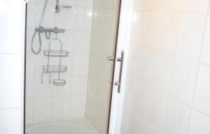 a shower in a bathroom with a glass door at La Parenthèse in Libramont