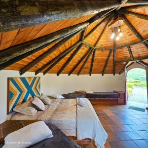 a bedroom with two beds in a attic at Ecohotel Buenavista in Villa de Leyva