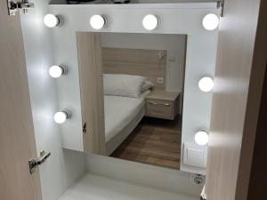 a mirror in a room with a bed and lights at Casa Luca in Carvoeiro +21 photos