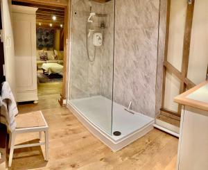 a shower with a glass door in a bathroom at Luxurious Country Barn in Baughurst +21 photos