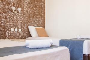 a hotel room with two beds and a table at Toros Otel Didim in Didim