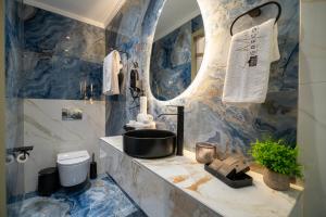 a bathroom with blue marble walls and a sink at Greek House Hotel in Neos Marmaras +71 photos