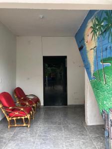 a room with chairs and a painting on the wall at Especial Beira Mar in Maragogi