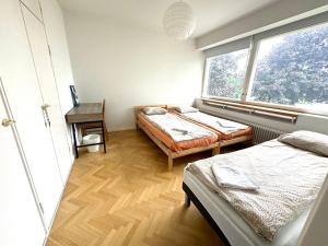 a bedroom with two beds and a window at Unique House only 3 min from the airport in Vantaa