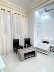 a living room with a couch and a table at STUDIO Wellness in Dakar +1 photo