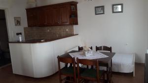 a kitchen with a table and a bed in a room at Villa 1930 first floor in Vóroi