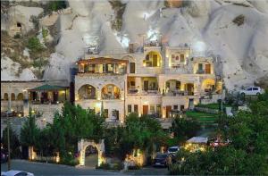 a large house in front of a mountain at Onur Cave Cappadocia in Goreme