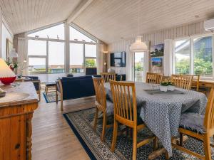 a dining room and living room with a table and chairs at 4 person holiday home in Sæby-By Traum in Sæby