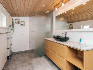 a bathroom with a sink and a mirror at 4 person holiday home in Sæby-By Traum in Sæby +52 photos