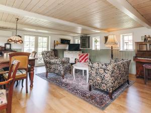 a living room with two chairs and a table at 4 person holiday home in Læsø-By Traum in Læsø