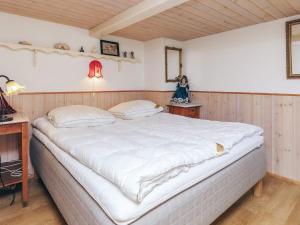 a bedroom with a large white bed in a room at 4 person holiday home in Læsø-By Traum in Læsø