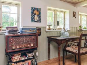 a room with a table and a chair and a table with a table at 4 person holiday home in Læsø-By Traum in Læsø +25 photos