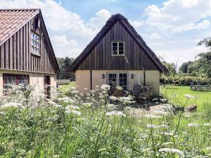 a barn with a table and chairs in a field at 4 person holiday home in Læsø-By Traum in Læsø