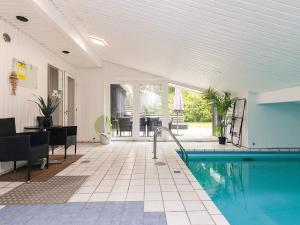 a house with a swimming pool and a dining room at 8 person holiday home in Ålbæk-By Traum in Ålbæk