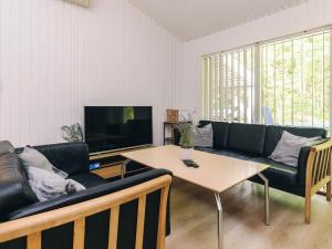a living room with a couch and a table at 8 person holiday home in Ålbæk-By Traum in Ålbæk