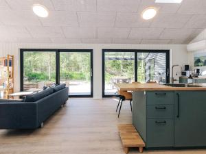 a kitchen and living room with a couch and a table at 5 star holiday home in Læsø in Læsø +35 photos
