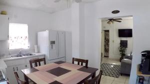 a kitchen with a table and a kitchen with a refrigerator at Hidden Hilltop Treasure in Charlotte Amalie
