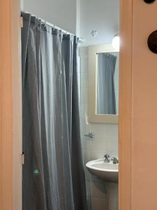 a bathroom with a shower curtain and a sink at Departamento frente al casino in Mar del Plata