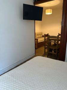 a room with a bed and a table and chairs at Departamento frente al casino in Mar del Plata