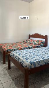 two beds sitting next to each other in a room at Meu Refúgio - Jer Eco Park in Salvaterra