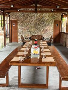 a large wooden table with wine glasses on it at Meu Refúgio - Jer Eco Park in Salvaterra +60 photos