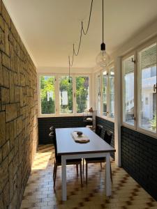 a dining room with a table and some windows at Nostalgia apartments in Jajce +48 photos