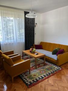 a living room with a couch and a coffee table at Nostalgia apartments in Jajce