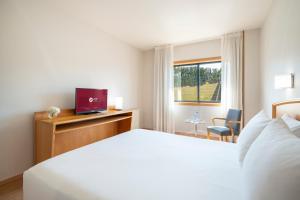 A bed or beds in a room at Exe Area Central
