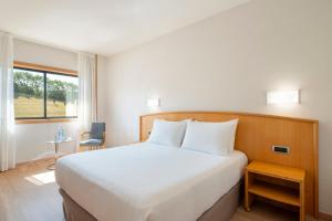 A bed or beds in a room at Exe Area Central