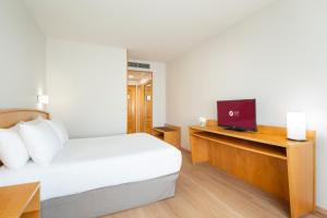 A bed or beds in a room at Exe Area Central