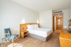 A bed or beds in a room at Exe Area Central
