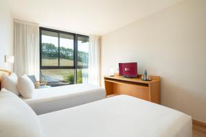 A bed or beds in a room at Exe Area Central