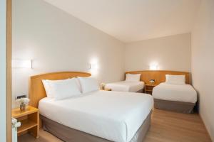 A bed or beds in a room at Exe Area Central