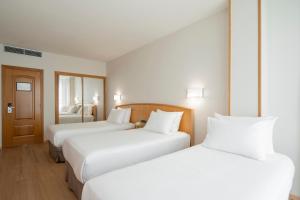 A bed or beds in a room at Exe Area Central