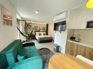 a living room with a green couch and a bed at Botique Studio - Casa El Sueño II in Vodnjan