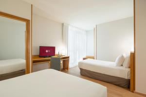 A bed or beds in a room at Exe Area Central