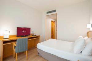 A bed or beds in a room at Exe Area Central