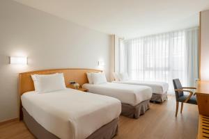 A bed or beds in a room at Exe Area Central