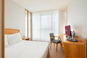 A bed or beds in a room at Exe Area Central