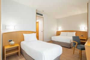 A bed or beds in a room at Exe Area Central