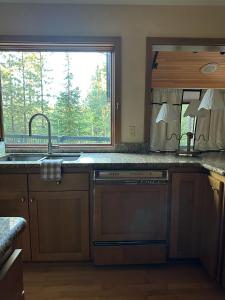 a kitchen with a sink and a window at Black Buttee Big Sister in Sisters