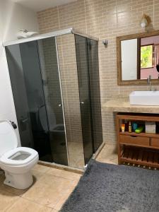 a bathroom with a shower and a toilet and a sink at Casa da Serra - Teresópolis in Teresópolis