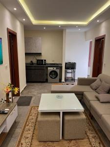 a living room with a couch and a table at Dream Chalet In Mirage Bay Resort in Hurghada