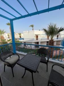 two chairs and a table on a balcony with a view at Dream Chalet In Mirage Bay Resort in Hurghada