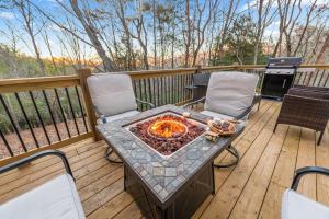 a table and chairs on a deck with a fire pit at Golf, Hot tub, Arcade, Poker Table, Wildlife, Internet, Pet Friendly, Name-May the Course Be With You in Ellijay
