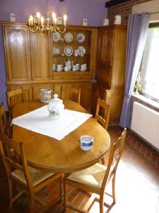 a dining room with a wooden table and chairs at La Parenthèse in Libramont