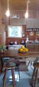 a kitchen with a table with a plate of fruit on it at Cabana in Annitapolis +45 photos