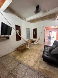 a living room with a couch and a hammock at Glamar Casa in Arboletes
